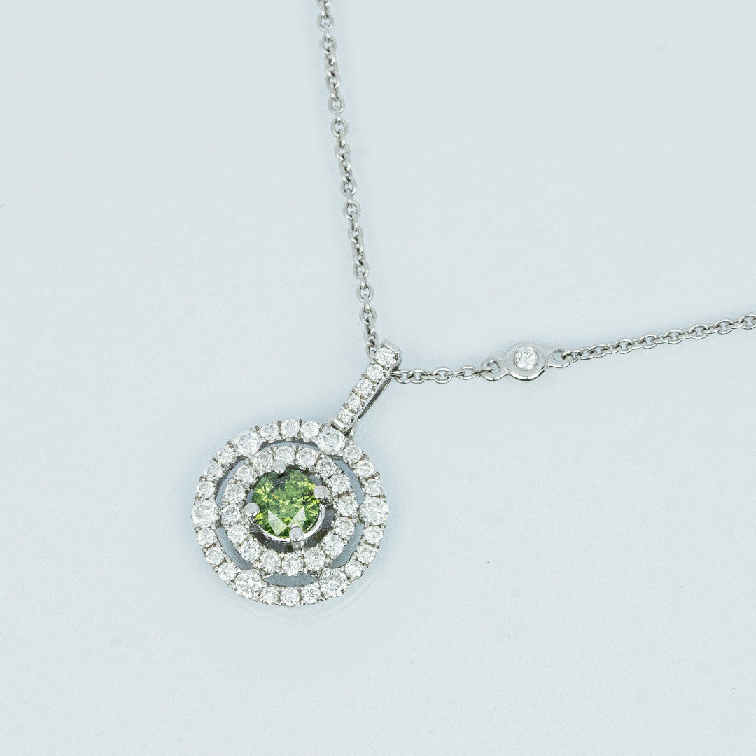 18 carat white gold green and white diamond halo pendant